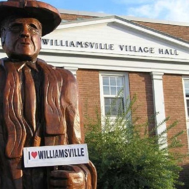 A picture of Village Hall with a sign that states "I love Williamsville".